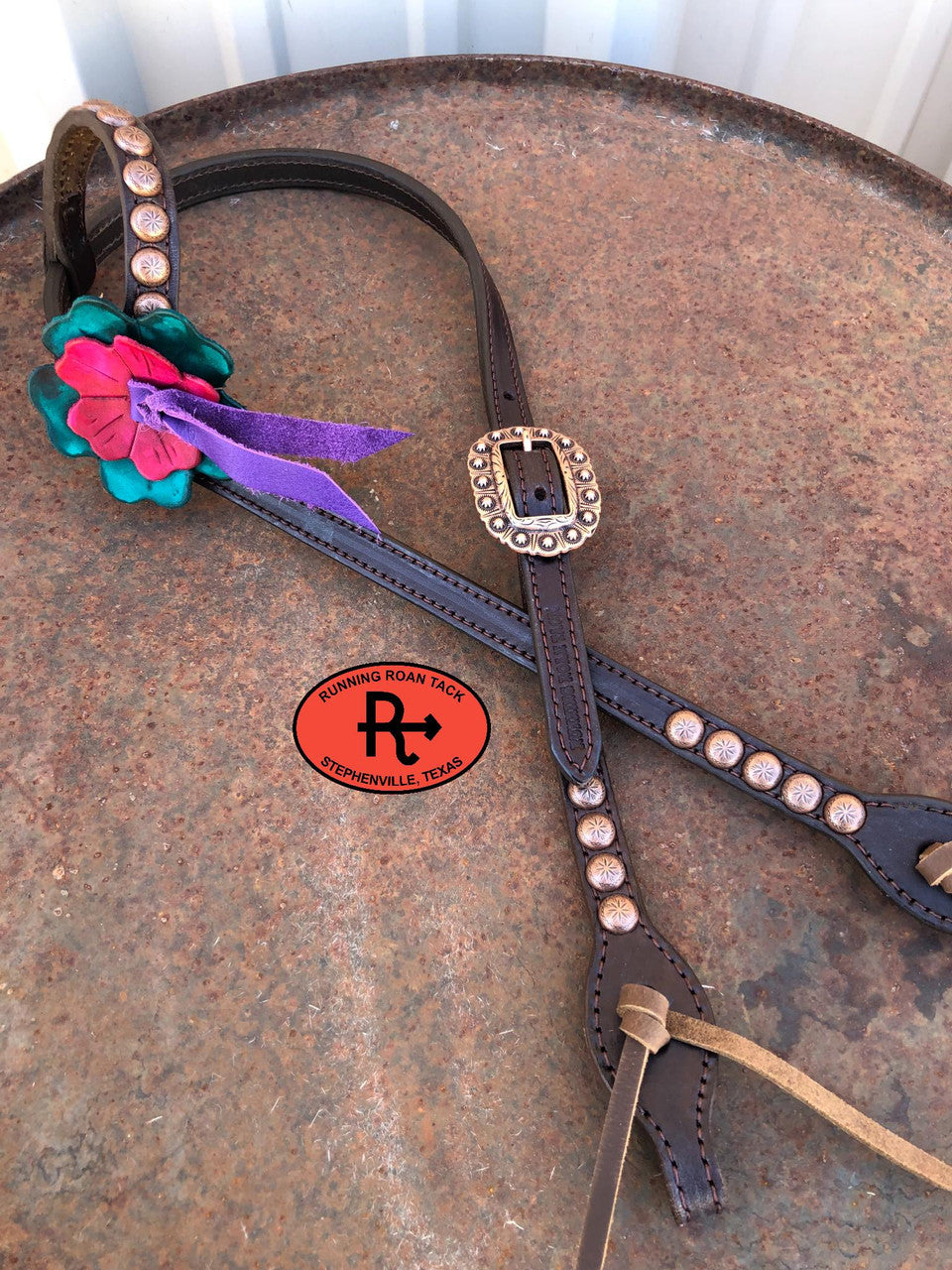 Headstall F: large teal flower, small red flower, purple blood knot, copper dots and buckle, brown oil tan ties at bit ends.