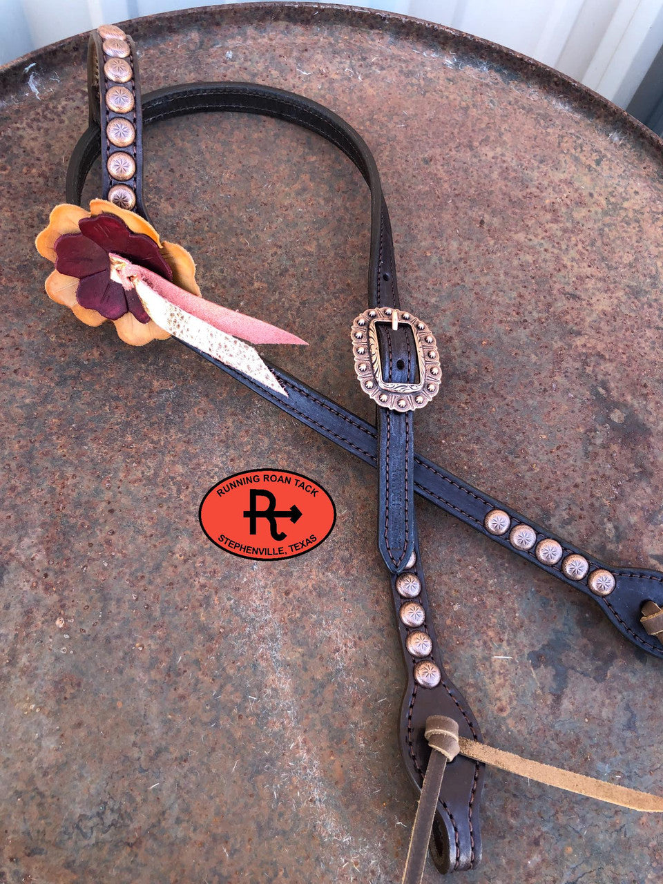Headstall E: large buckskin flower, small burgundy flower, metallic rose gold blood knot, copper dots and buckle, brown oil tan ties at bit ends.